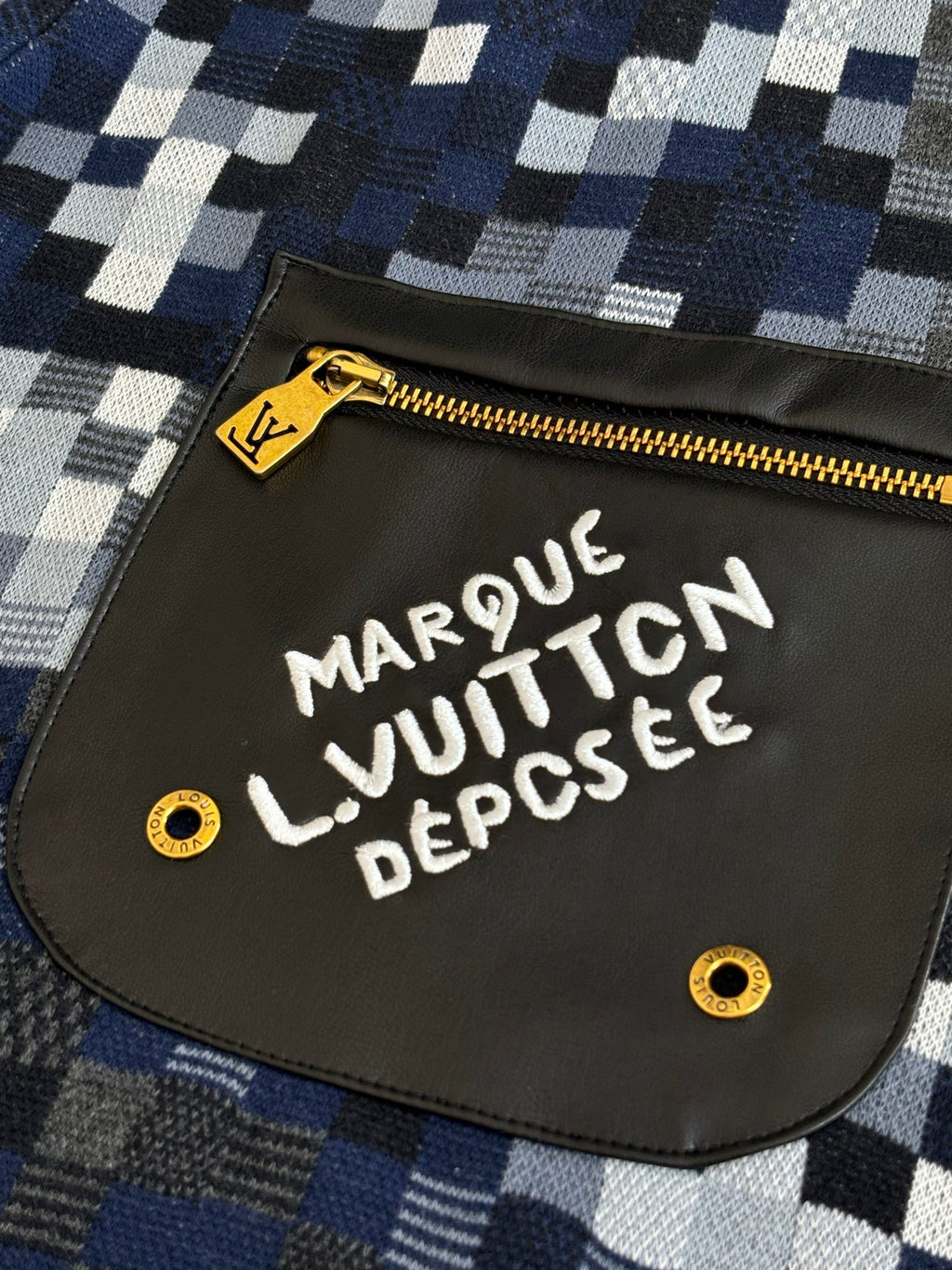 Louis Vuitton logo patch pocket on shorts with gold zipper and white lettering