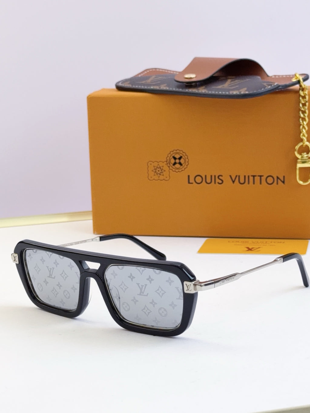Louis Vuitton sunglasses with black frames and light patterned lenses