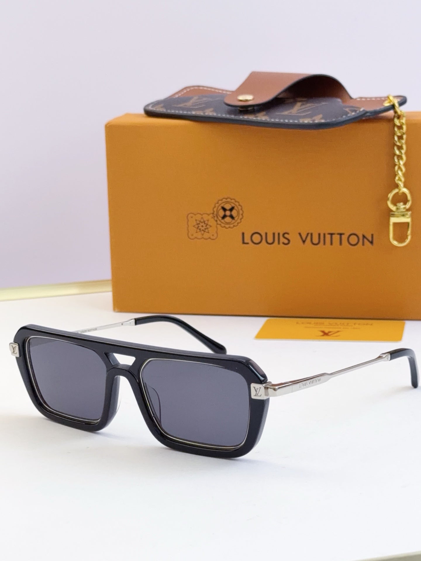 Louis Vuitton sunglasses with black frames and dark blue lenses