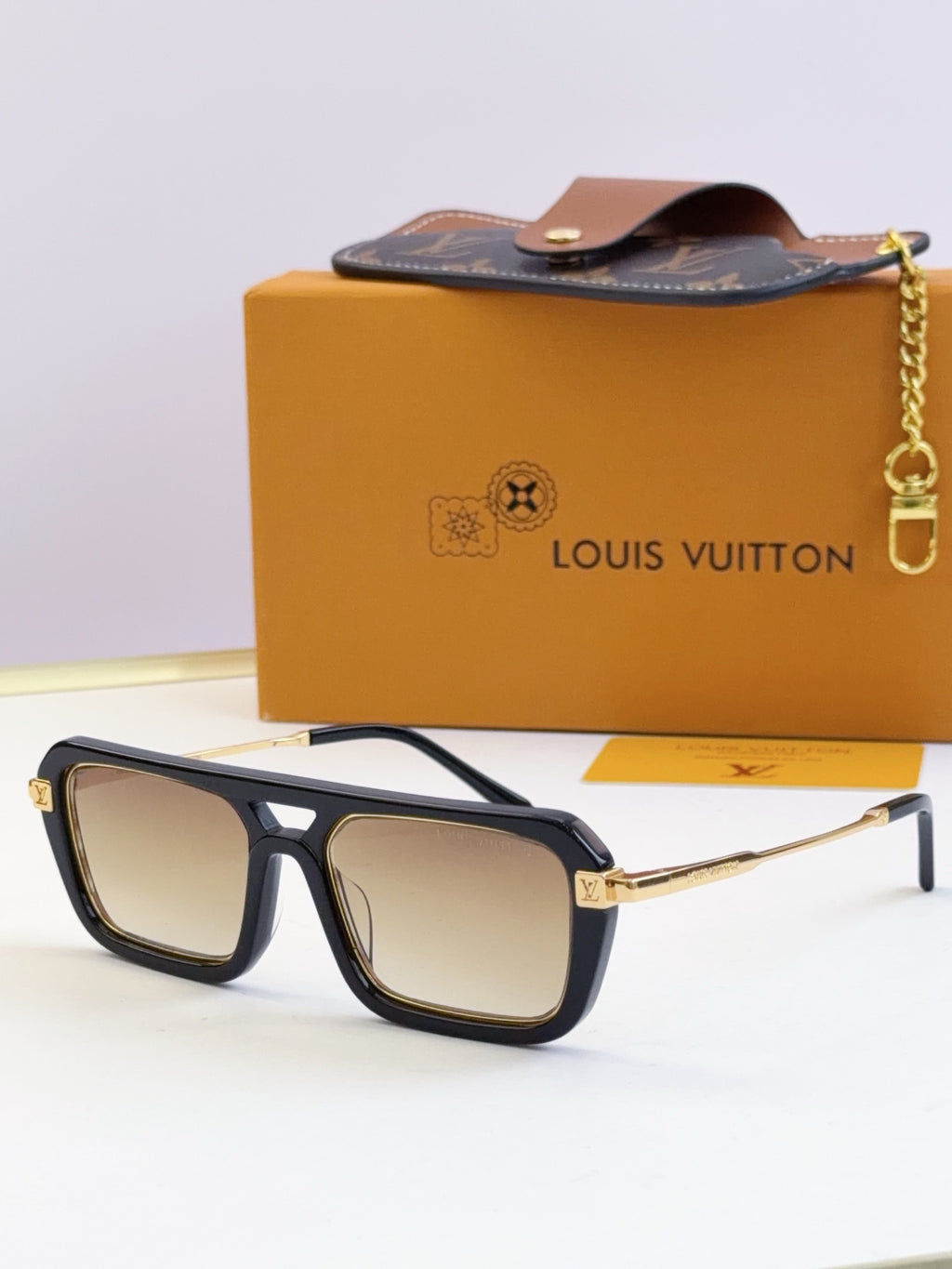 Louis Vuitton sunglasses with black frames and light beige lenses