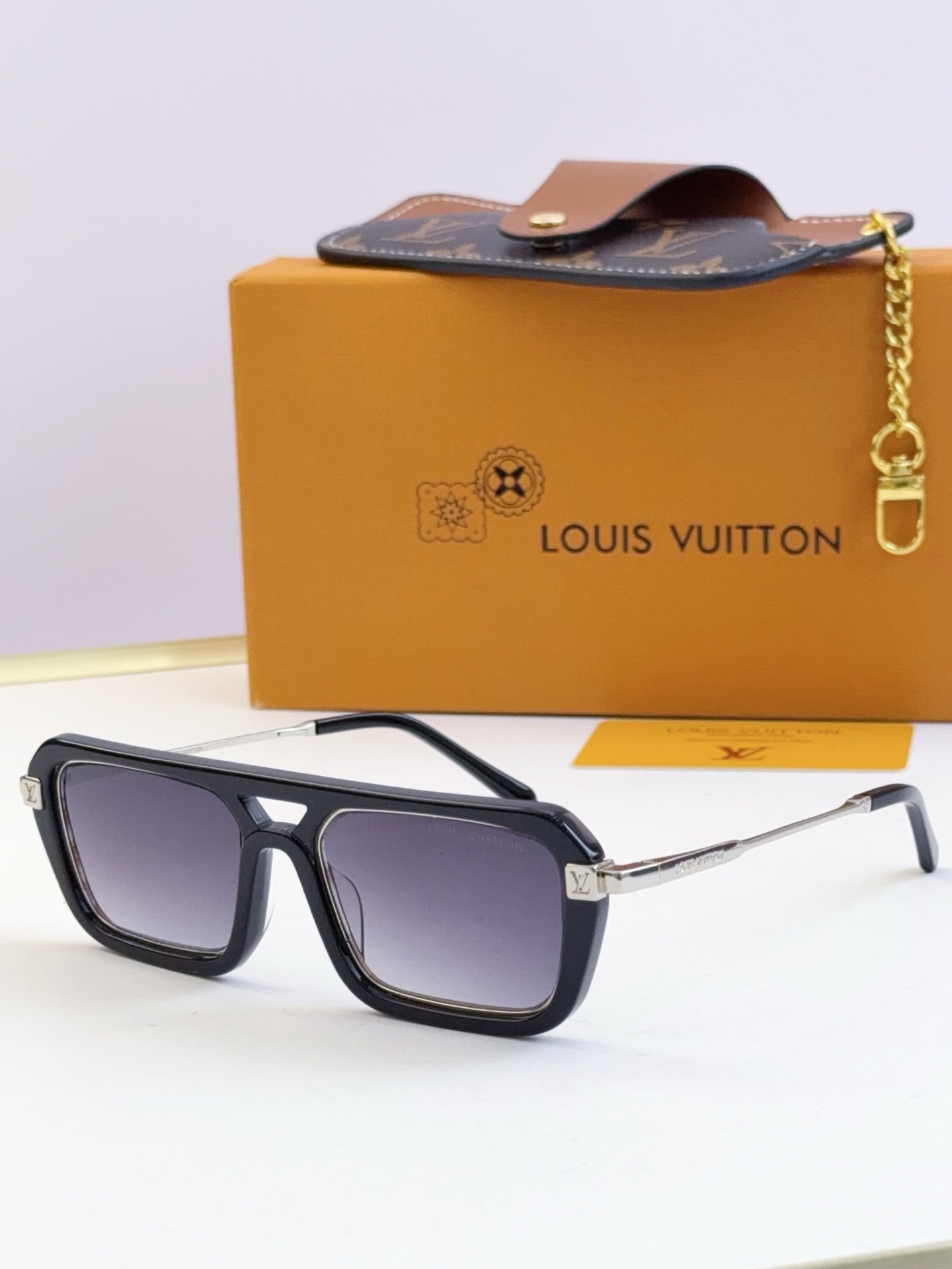 Louis Vuitton sunglasses with dark frames and blue-tinted lenses, front view