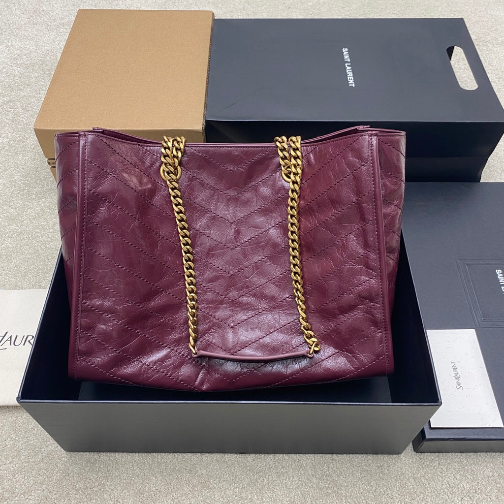 Burgundy quilted leather tote bag with gold chain straps and center YSL logo