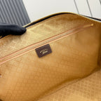 Gucci bag interior close-up with tan lining, stitched edges, and small fabric logo patch.