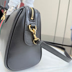 Gucci shoulder bag in black leather with gold zipper pull and chain strap