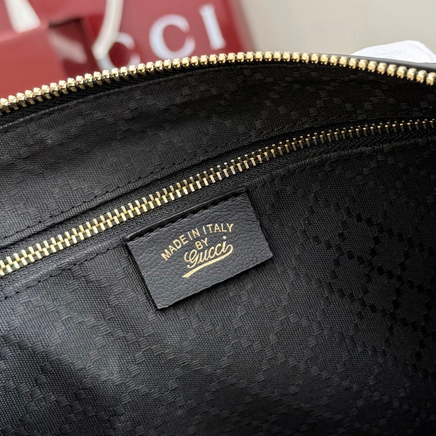 Gucci handbag interior label reading "Made in Italy" and quilted lining.