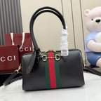 Black Gucci handbag with top handles, green-red stripe and gold-tone hardware.