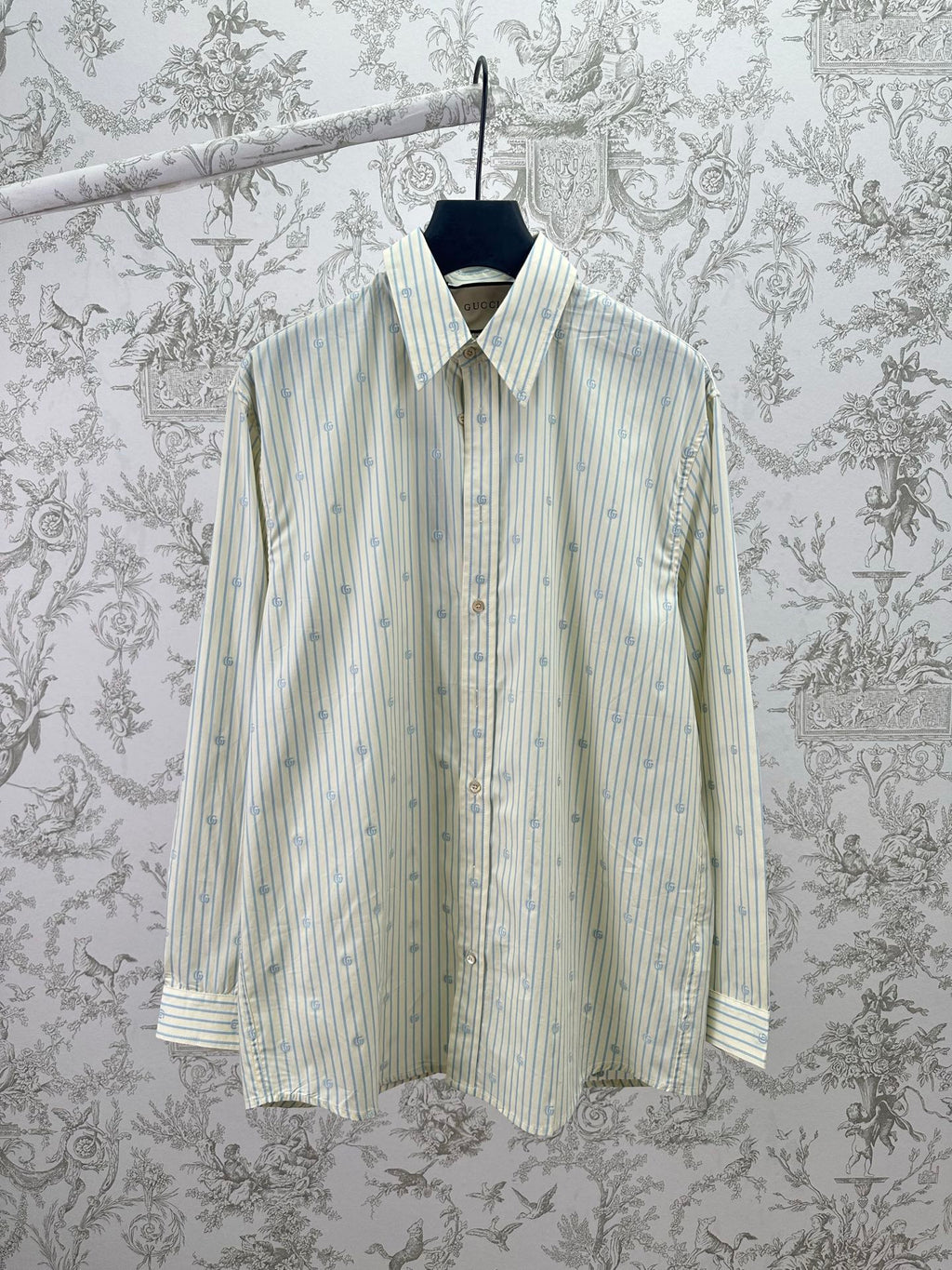 Light blue striped button-up shirt with pointed collar and button placket