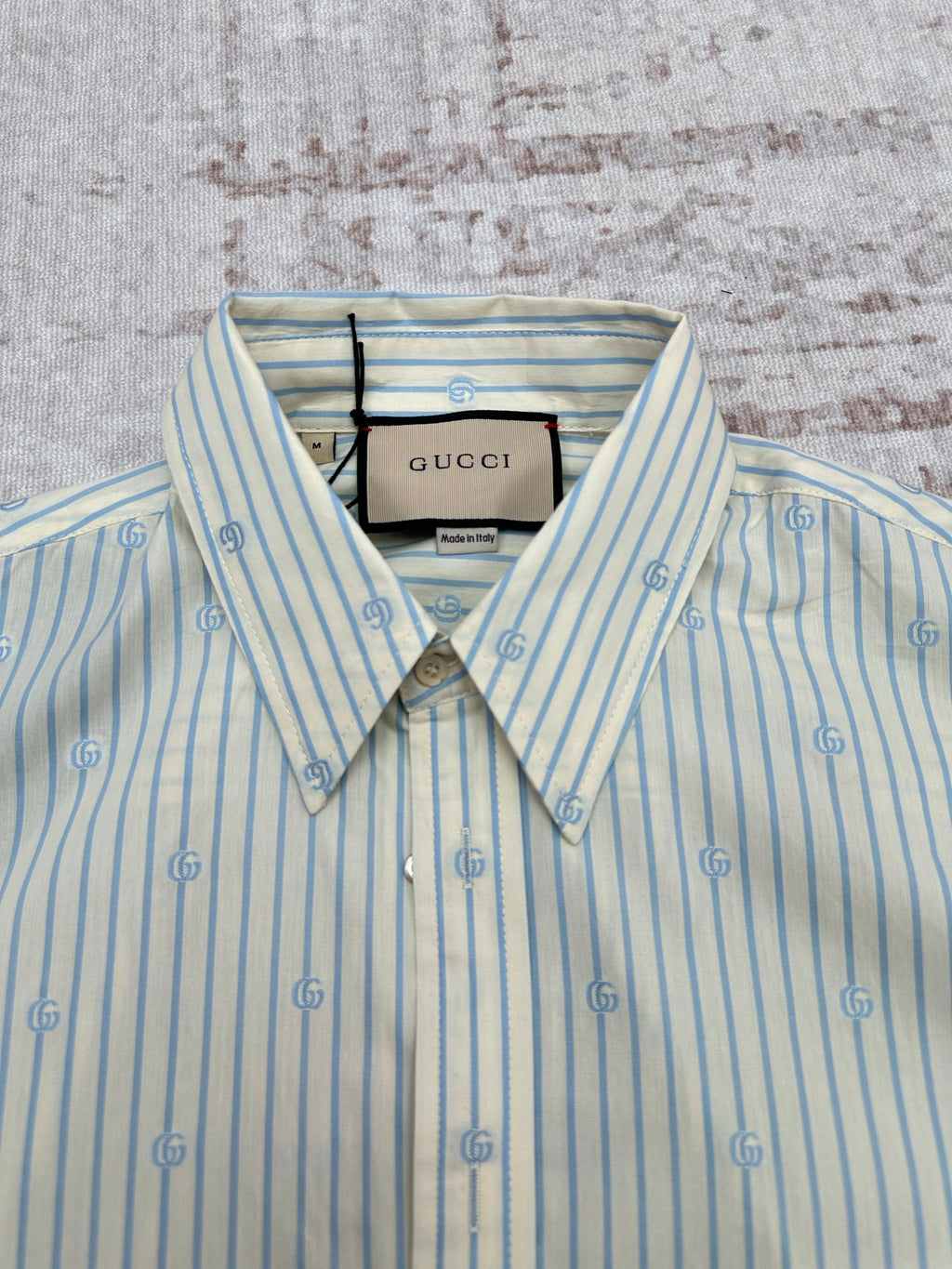 Light blue striped button-up shirt with spread collar and Gucci neck label