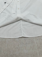 White shirt hem with wide front panels and buttoned neckline