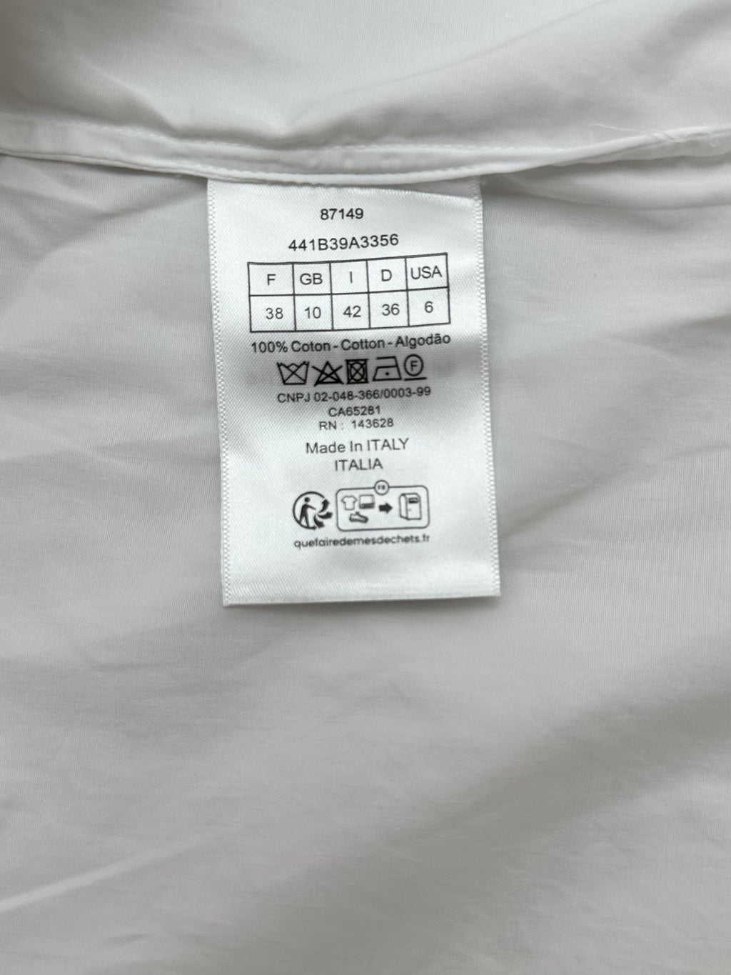 White shirt inside neck label with size, fabric and origin information