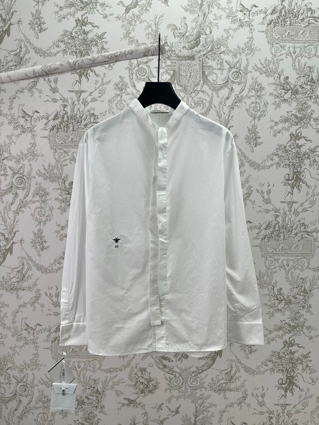 White long-sleeve button-up shirt with pointed collar and small chest logo