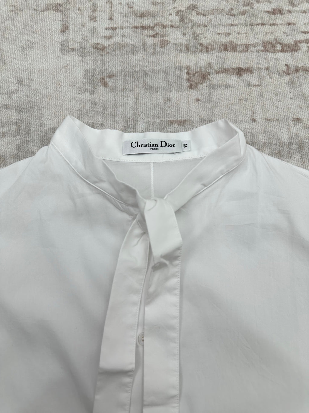 White button-up shirt neckline with front placket and buttoned tie collar