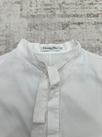 White button-up shirt neckline with front placket and buttoned tie collar