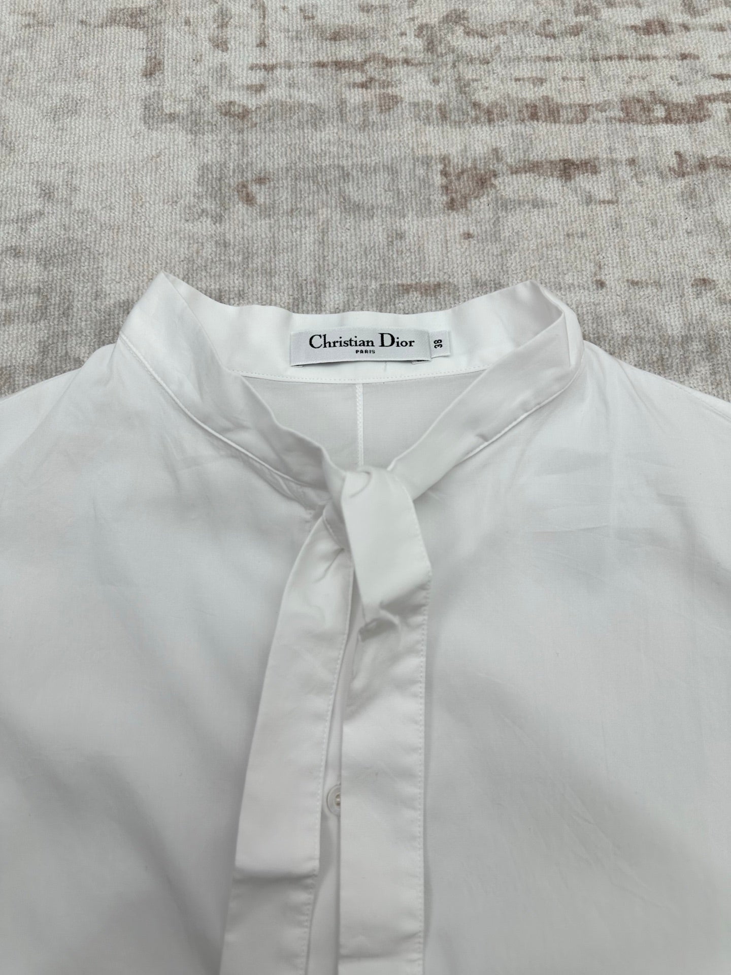 White button-up shirt neckline with front placket and buttoned tie collar