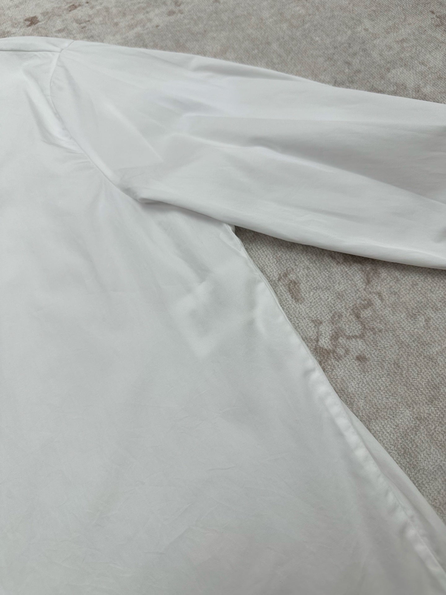 White long-sleeve shirt with smooth fabric and side seam detail