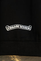 Black hoodie lower graphic text 'Chrome Hearts' in white