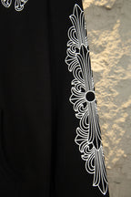 Black hoodie sleeve close-up with white feather-style graphic