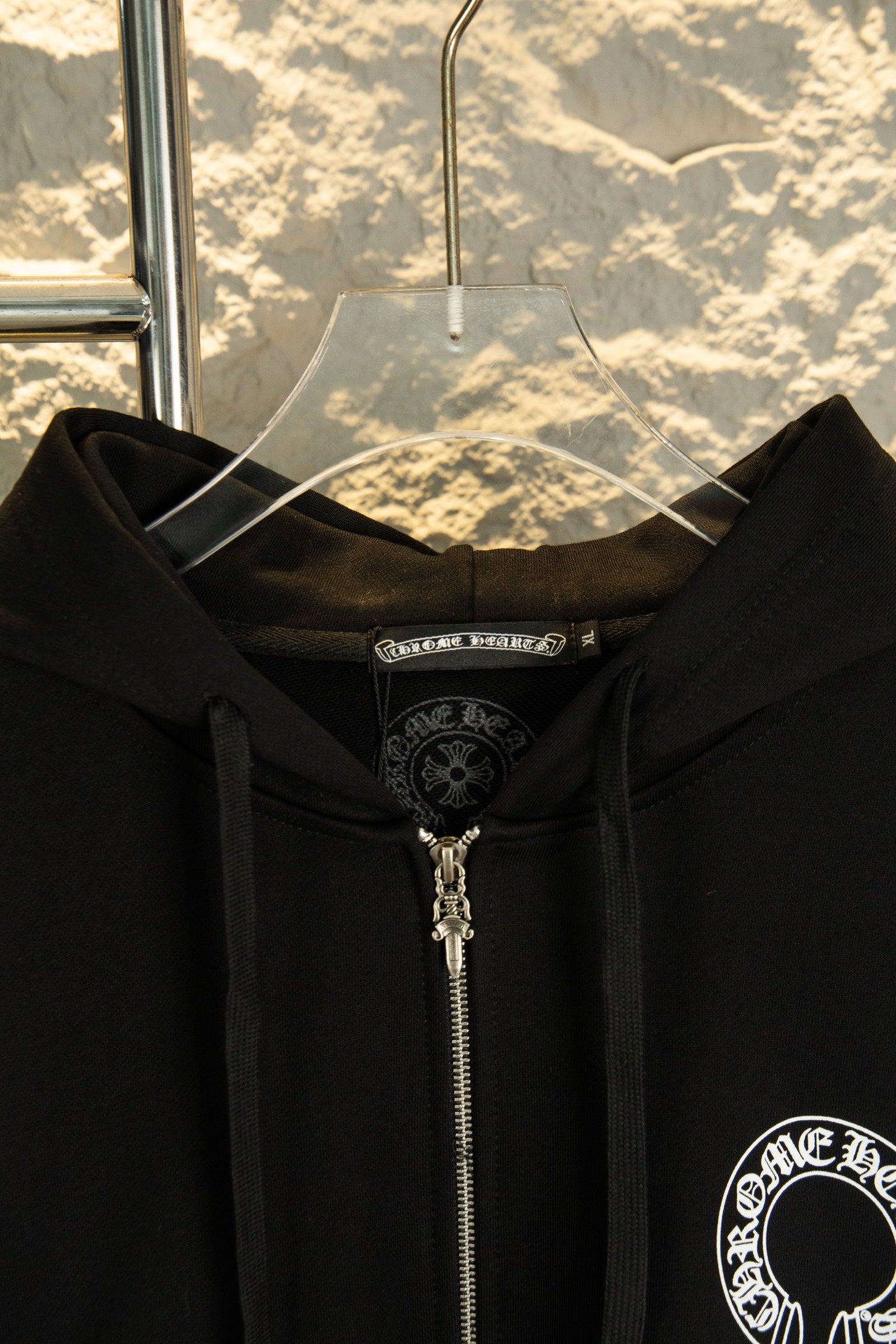 Black hoodie hood and front zipper with small embroidered chest crest