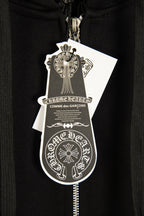 Black hoodie with silver zipper pull and hanging brand shield tag.