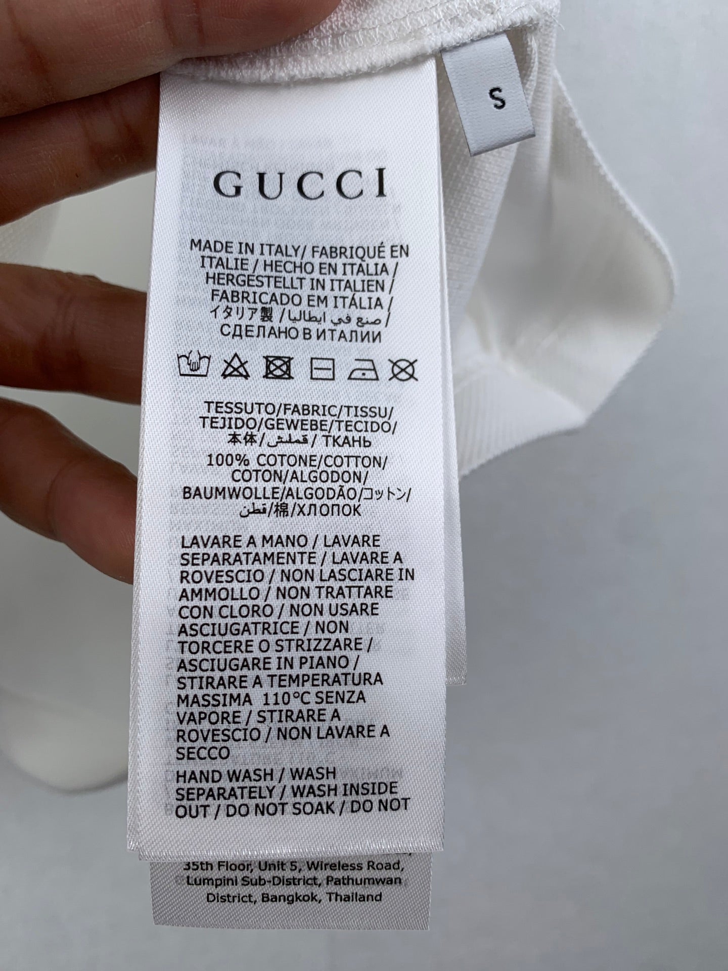 Gucci shorts care label tag on white fabric waistband