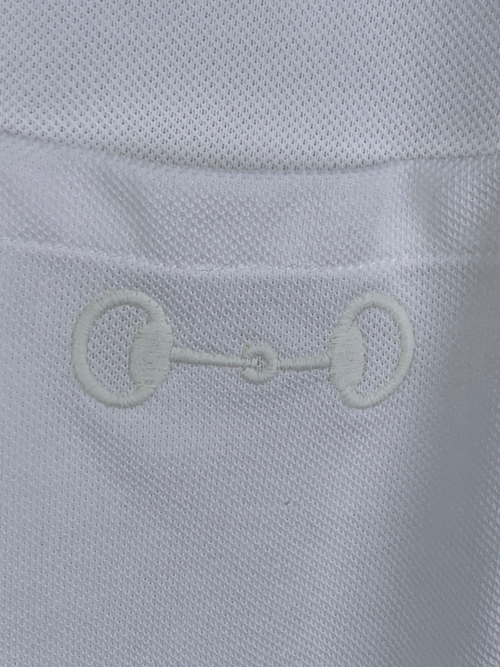 Gucci white T-shirt fabric close-up with embroidered chain-link logo