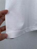 Gucci white T-shirt side seam close-up held by hand