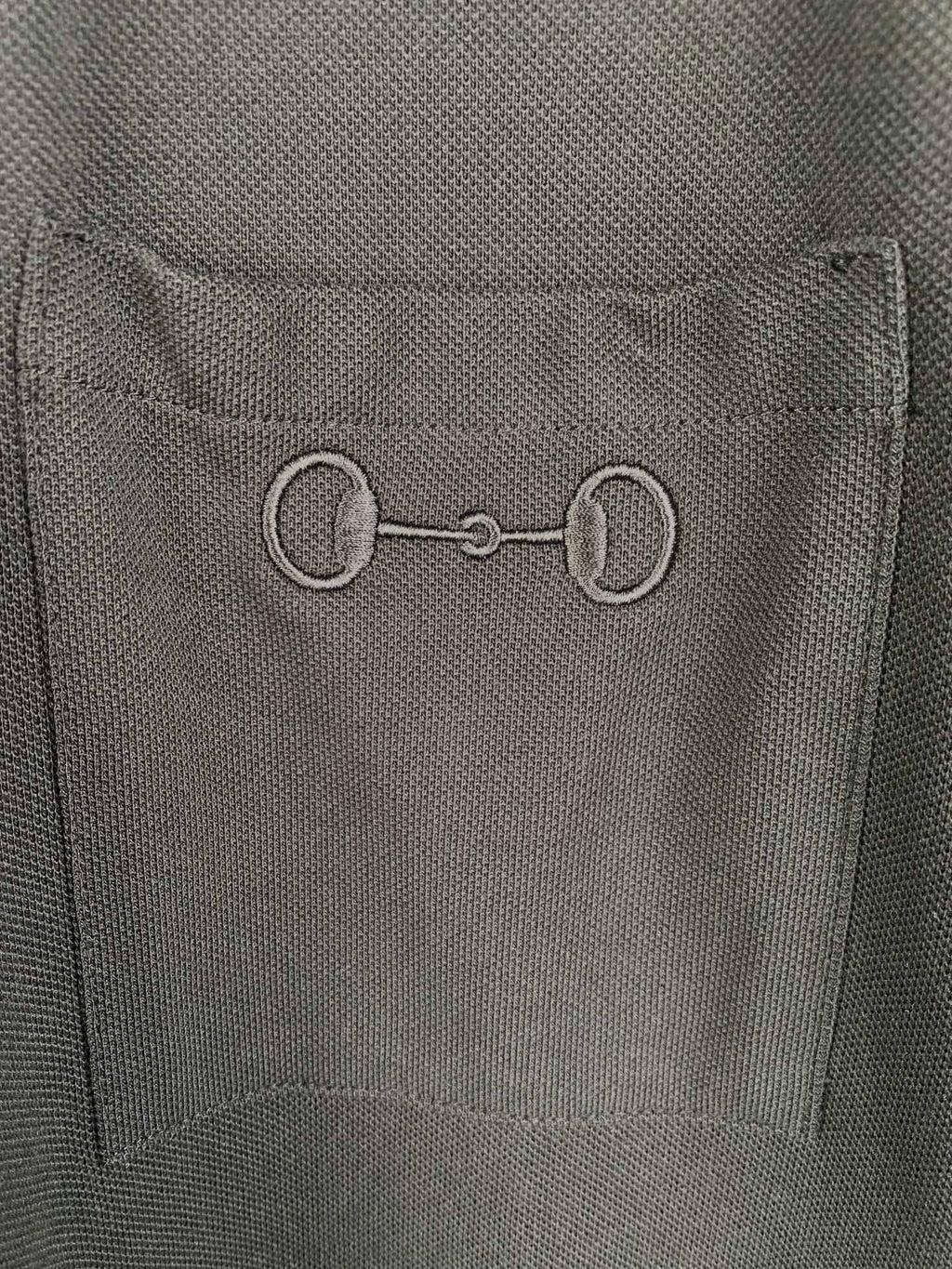 Close-up of Gucci inner neck label on a dark crew-neck T-shirt