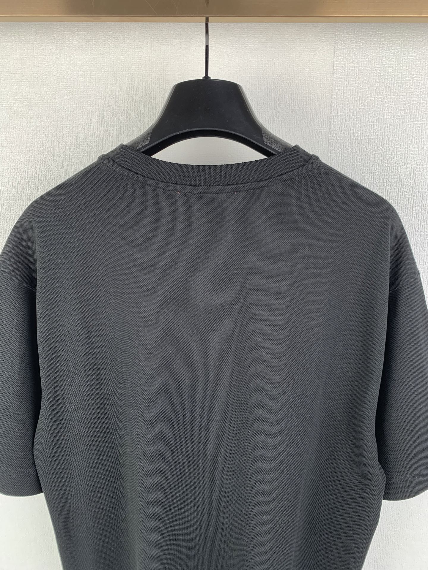 Dark charcoal crew-neck T-shirt back with clean neckline and smooth fabric