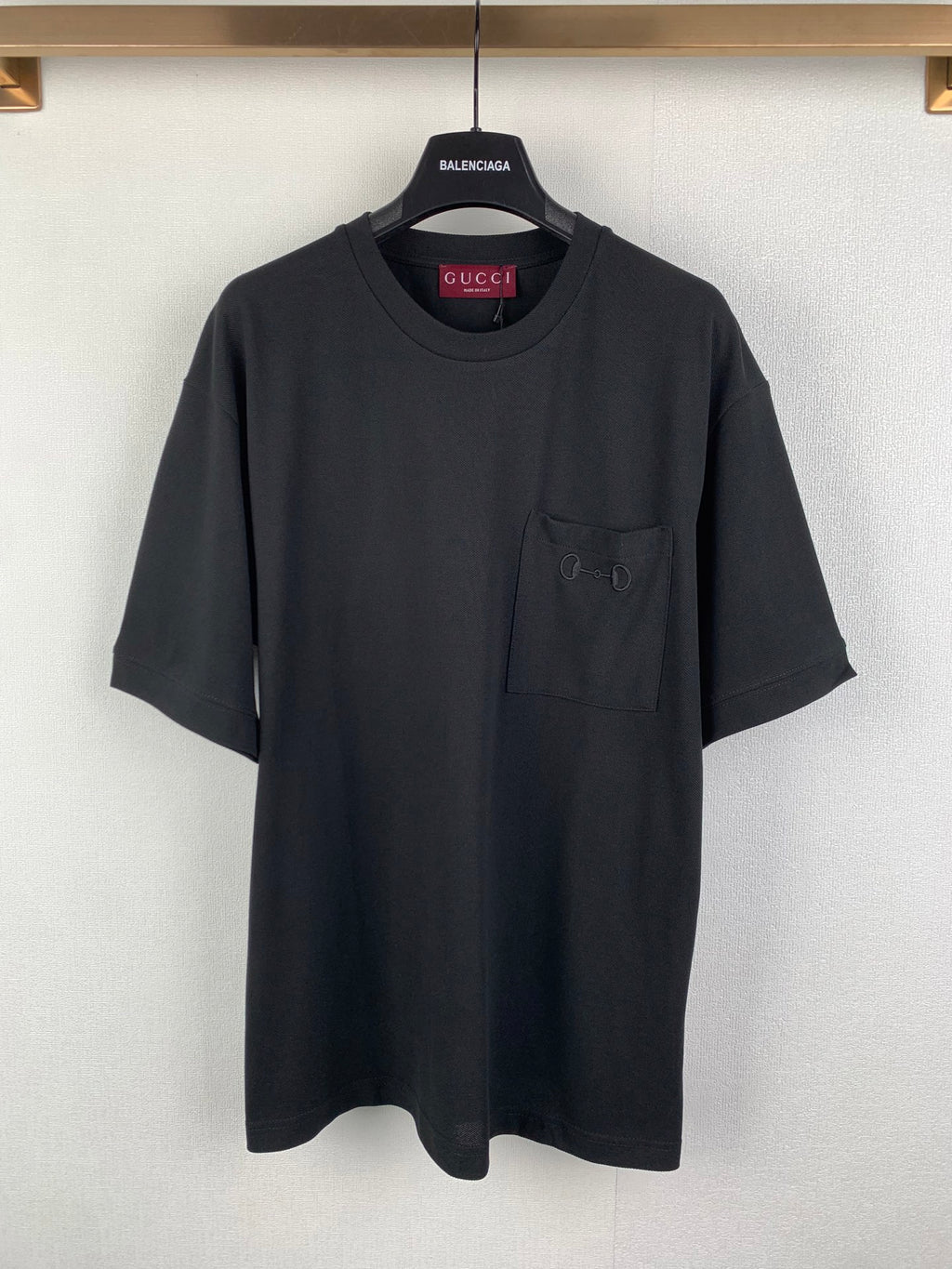 Dark charcoal crew-neck T-shirt with short sleeves and a chest pocket