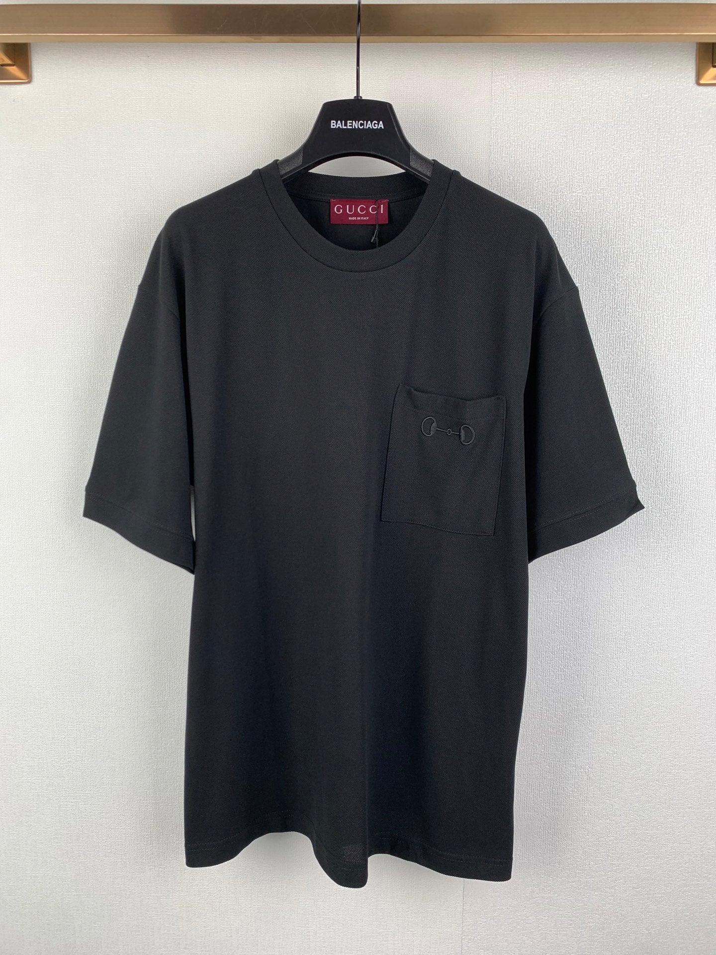 Dark charcoal crew-neck T-shirt with short sleeves and a chest pocket