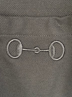 Close-up of Gucci label with metal-like emblem detail on a dark T-shirt