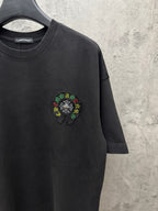 Black short-sleeve T-shirt with small multicolor circular chest embroidery.