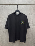 Black crewneck short-sleeve T-shirt on hanger, small multicolor chest embroidery.