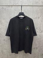 Black crewneck short-sleeve T-shirt on hanger, small multicolor chest embroidery.