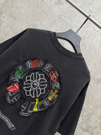 Black T-shirt close-up of circular flower and character patch embroidery.