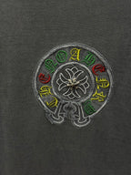 Grey T-shirt fabric with circular multicolor embroidered flower emblem