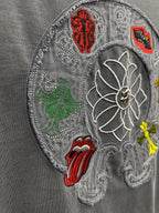 Grey T-shirt close-up of large embroidered back patch with floral and symbols