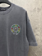 Grey short-sleeve T-shirt with small circular embroidered chest emblem