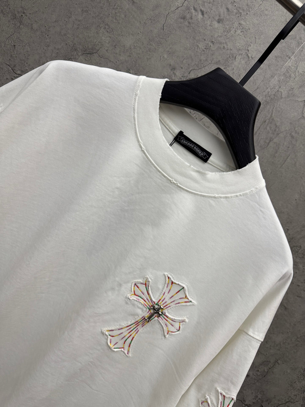 White short-sleeve T-shirt close-up of chest cross embroidery and crew neckline