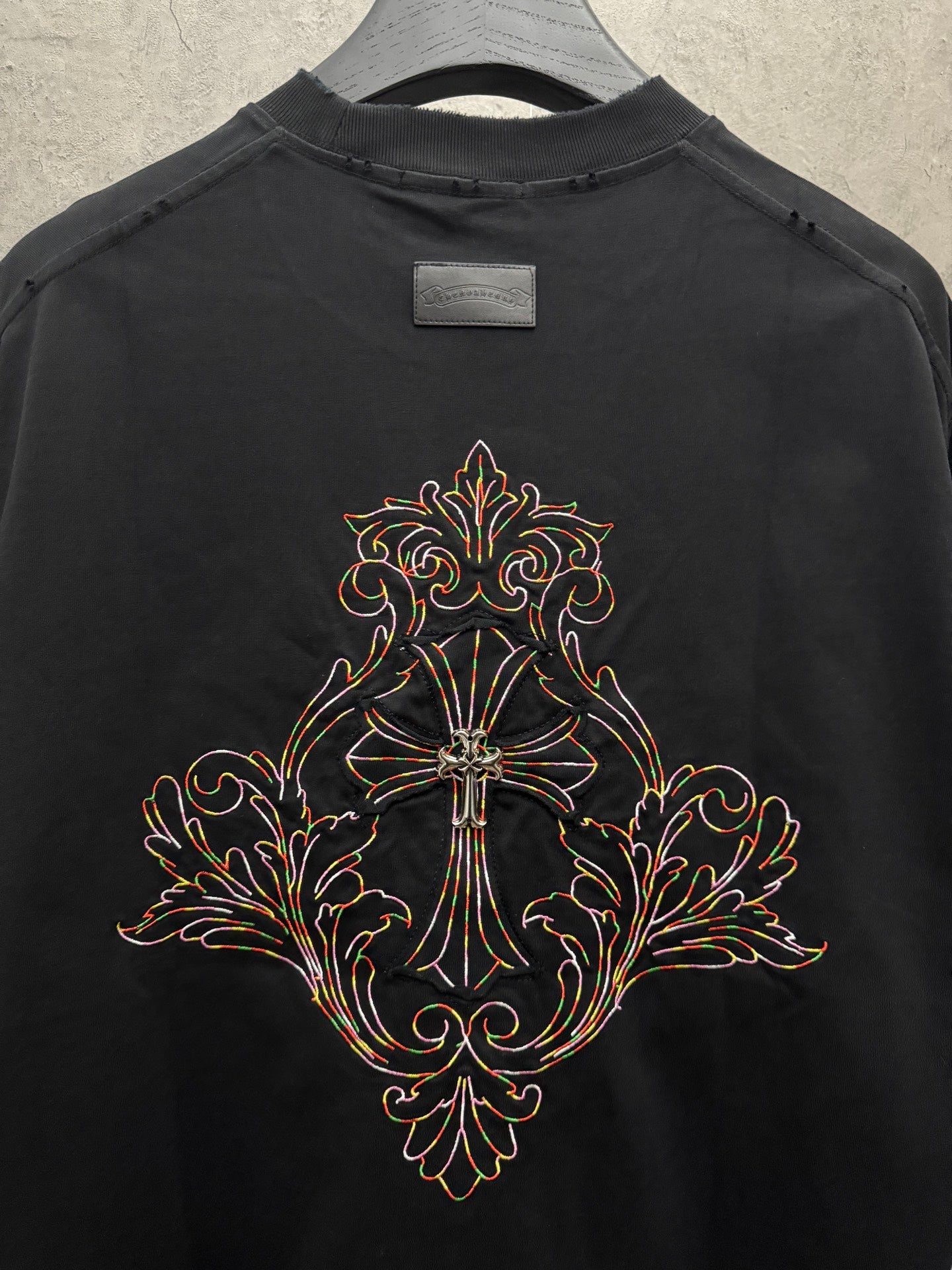 Black short-sleeve T-shirt with large ornate cross embroidery on back center
