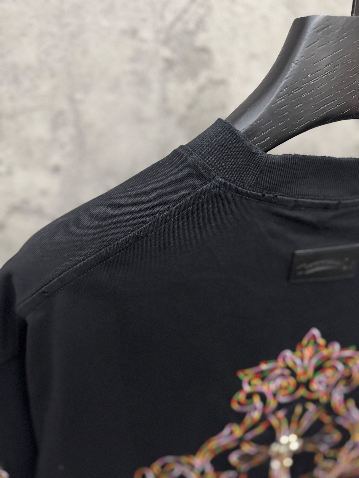 Black short-sleeve T-shirt with crew neck and small back label detail