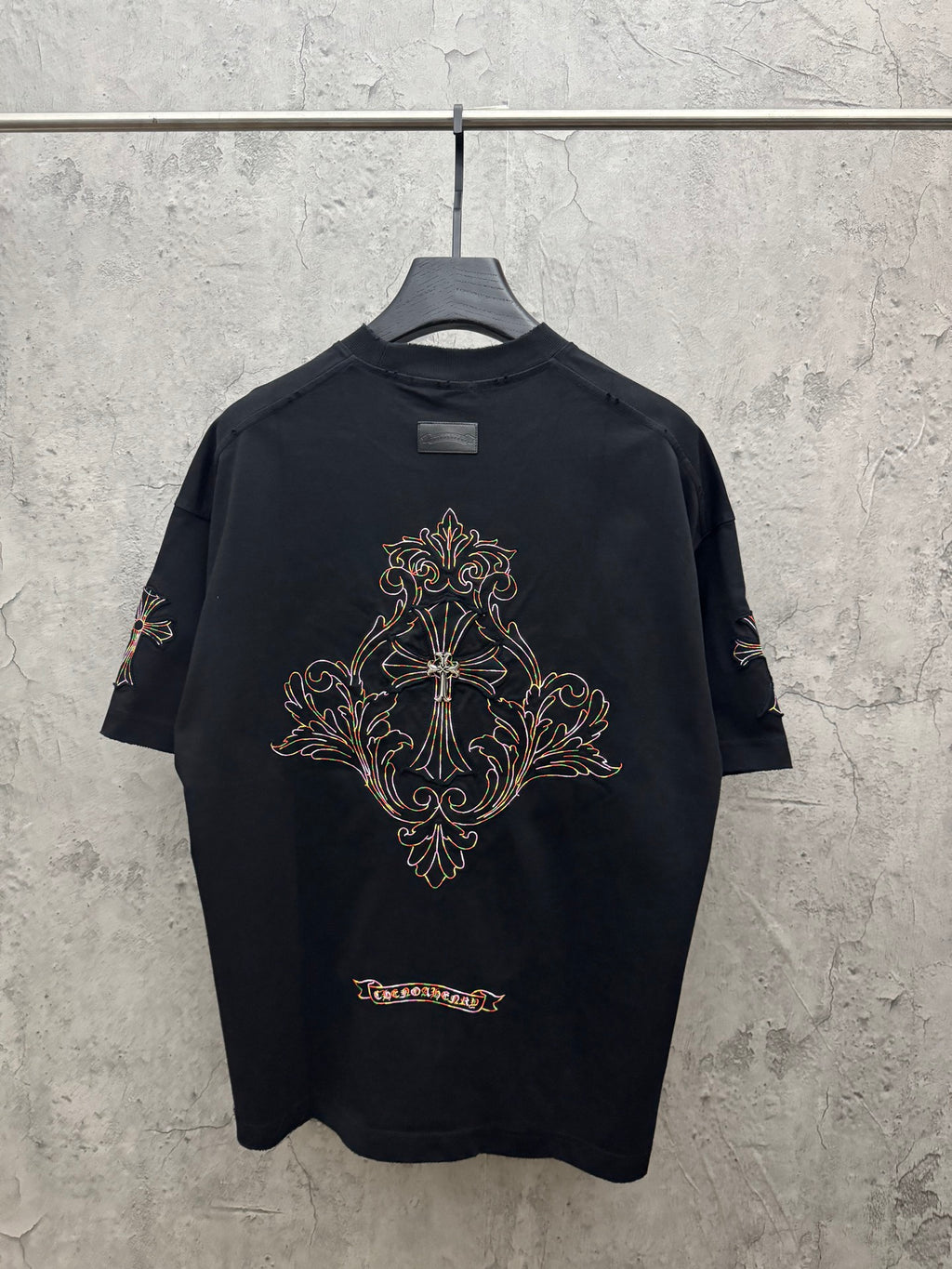 Black short-sleeve T-shirt with ornate cross embroidery on upper back