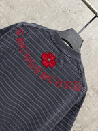 Navy striped short-sleeve shirt with red flower and script embroidery across chest