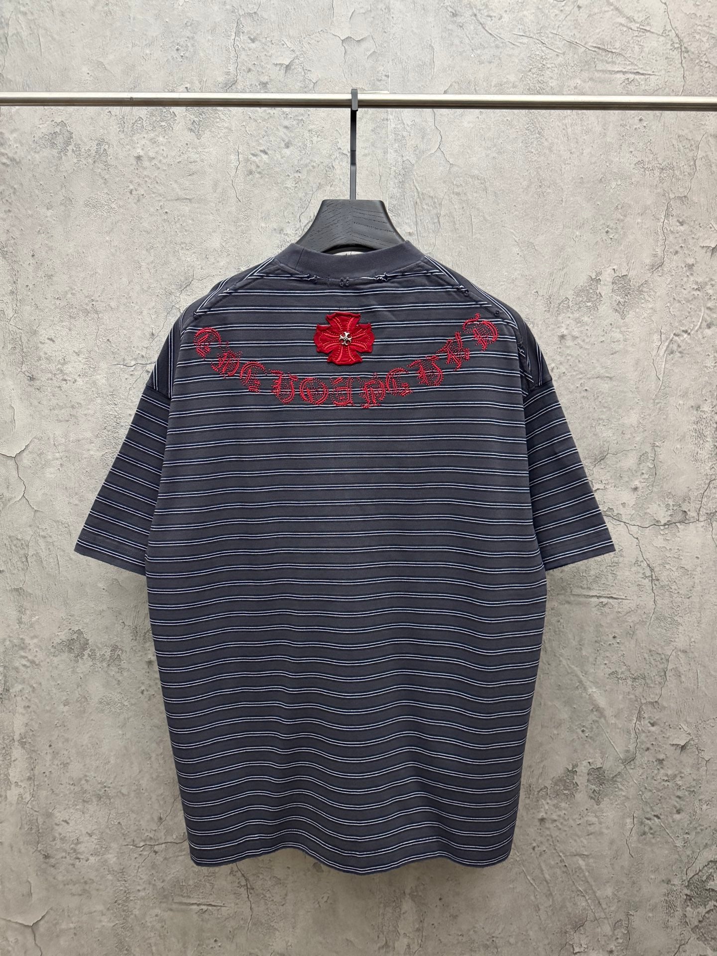 Navy short-sleeve striped crewneck shirt with red flower embroidery on back