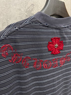Navy striped short-sleeve shirt with red flower appliqué and script embroidery