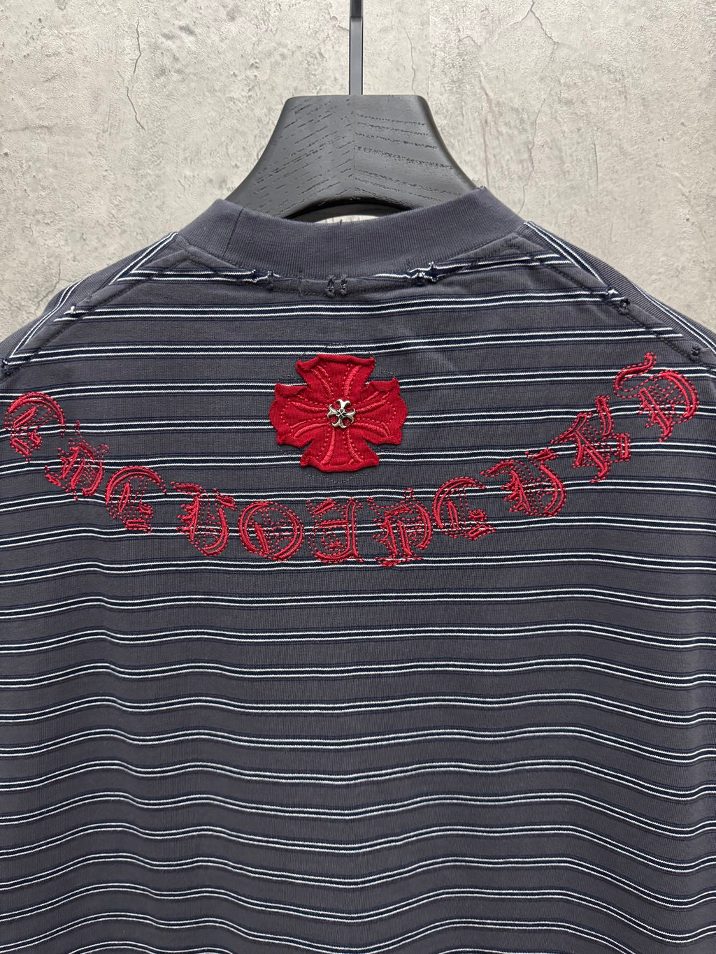 Navy striped short-sleeve crewneck shirt with red flower and script embroidery