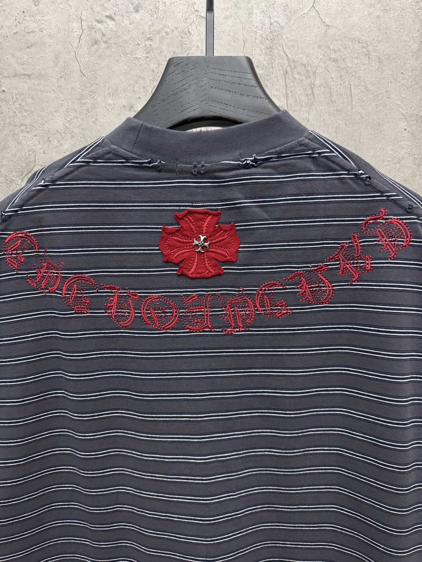 Navy striped short-sleeve crewneck shirt with red flower and script embroidery