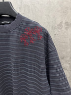 Navy striped short-sleeve crewneck shirt with red starburst chest embroidery