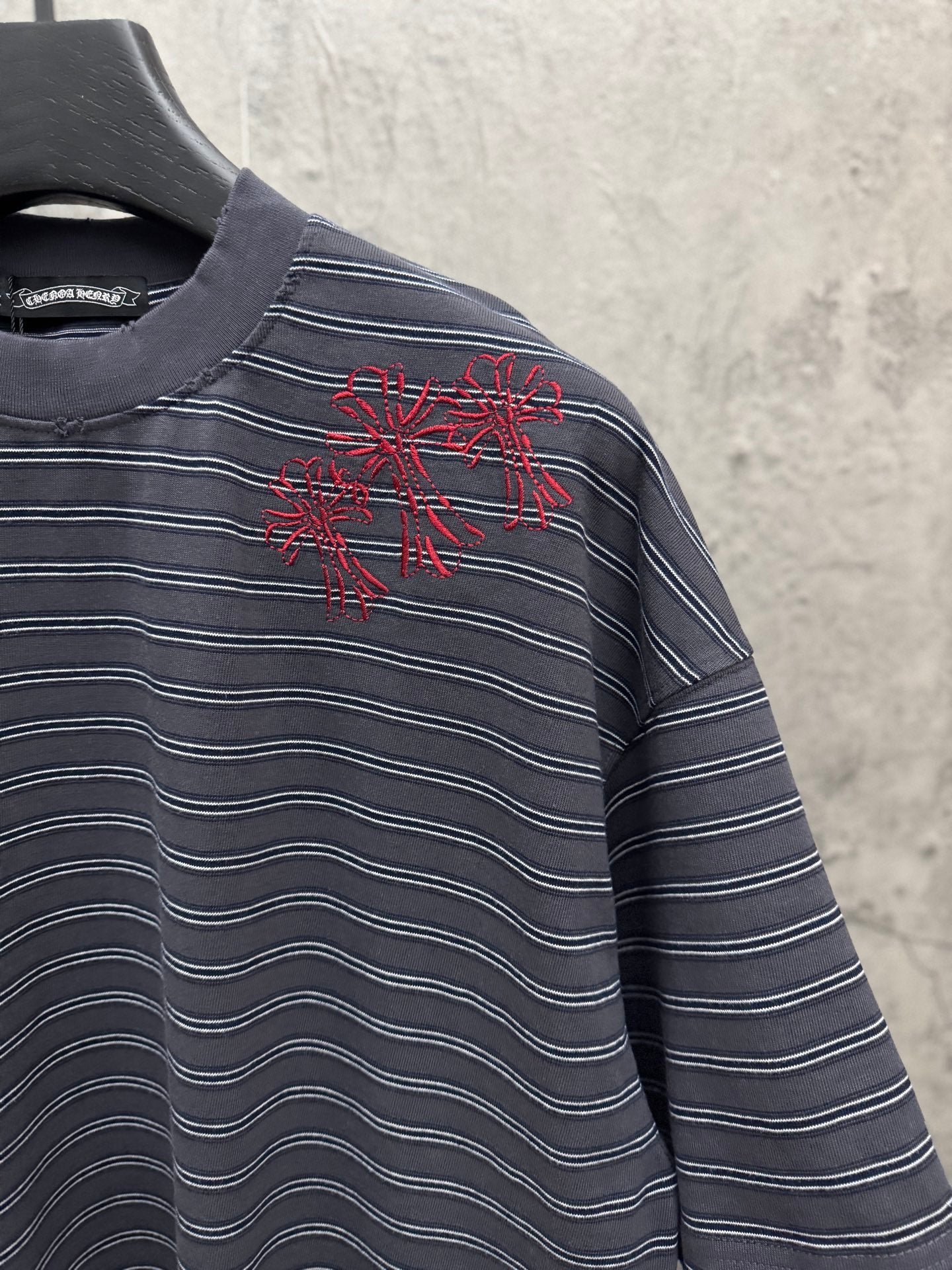 Navy striped short-sleeve crewneck shirt with red starburst chest embroidery