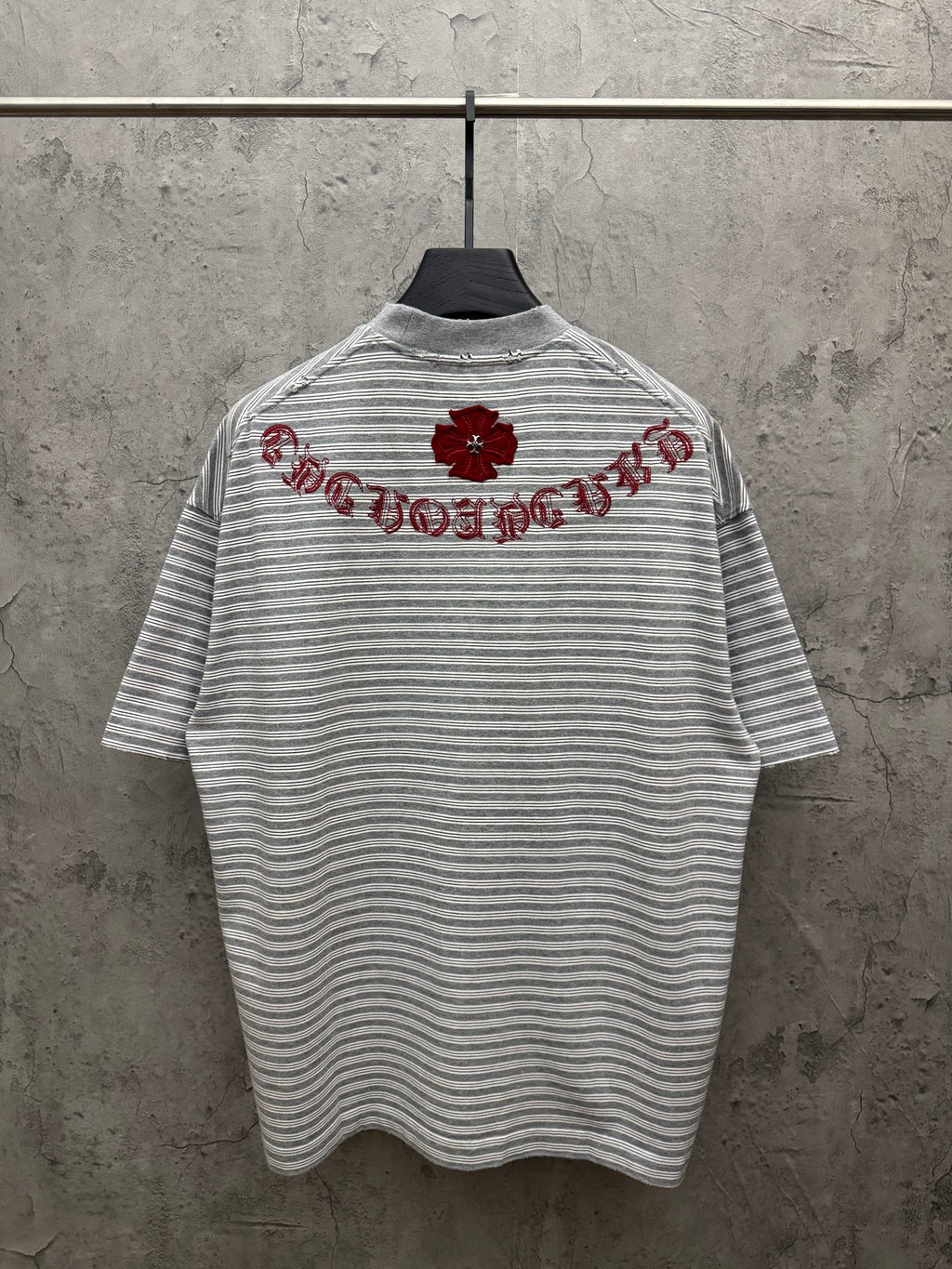 Striped short-sleeve T-shirt with red embroidered script across upper back, crew neck.